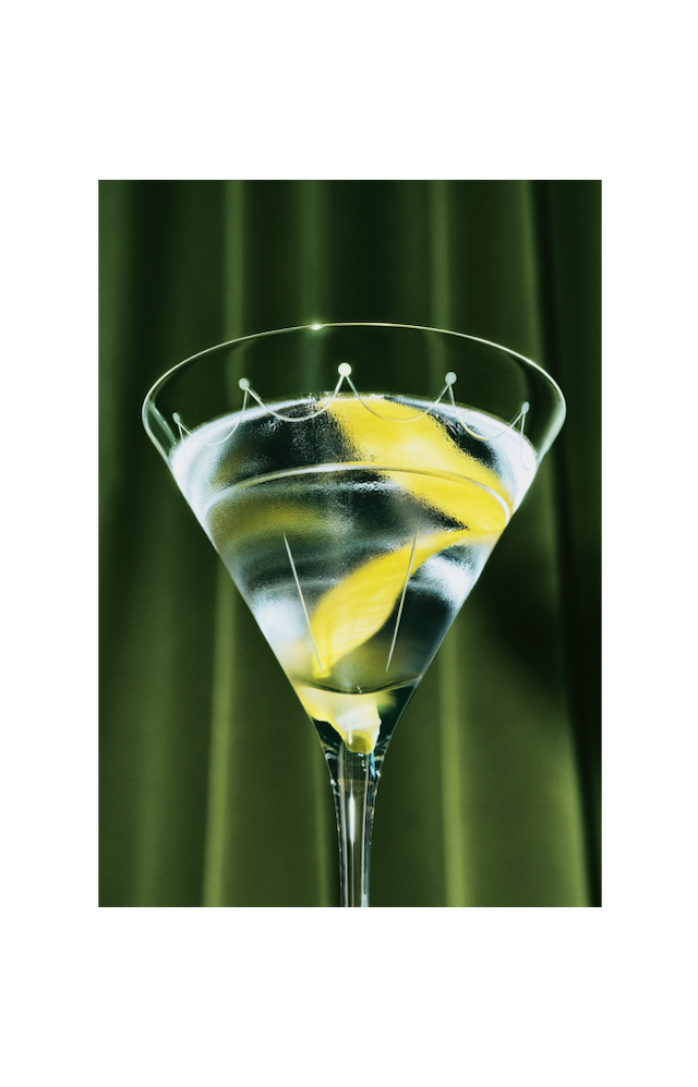 A close up view of a Martini with a twist of lemon, viewed from below.